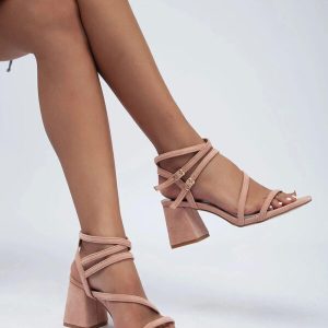 Pair of strappy pink high heel sandals with a block heel and open toe design.